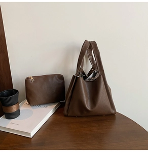 Detail of dark brown lychee pattern leather tote bag set with matching inner pouch