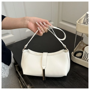 Detail showing the white PU leather handbag with elegant gold metal buckle and handle