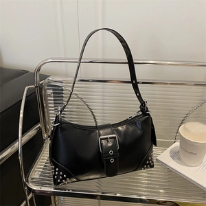 Chic black crescent shoulder bag with silver buckle and rivets on modern display stand
