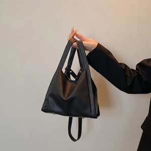 Litchi pattern leather bucket bag in black with gold metal studs and top handles