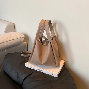 Minimalist lychee pattern bucket bag in beige with geometric design and twin handles