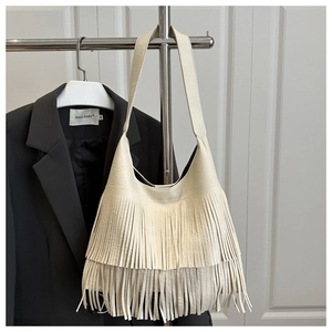 Détail du sac cabas en cuir beige avec franges double couche et large bandoulière