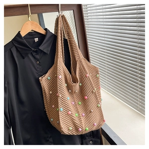 Detail of hand-crocheted brown tote bag with colorful acrylic beads and hollow-out knit