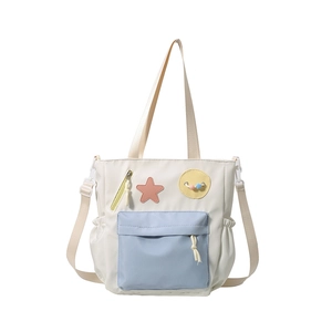 Minimalist multi-functional white nylon tote bag with blue zipper pocket and stars