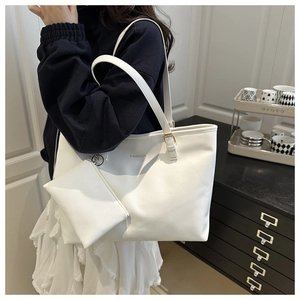 Detail of white Saffiano PU tote bag with gold FASHION text and matching mini pouch