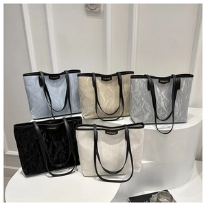 Detailed display of tote bags with pleated texture in multiple colors on minimalist pedestals