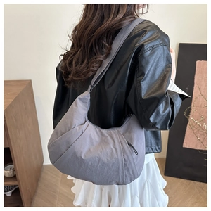 Detailed back view of a grey pleated nylon crescent shoulder bag for women