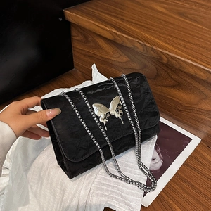 Chic black pleated shoulder bag with oversized silver butterfly buckle and chain strap