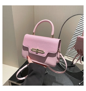 Detail of the pink leather bag showing the mix of textured litchi and smooth grain finish