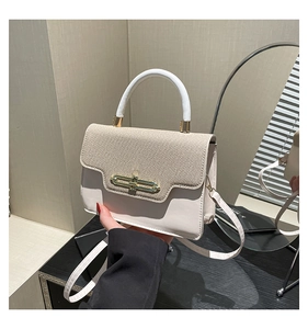Close-up of stylish cream PU leather crossbody bag with khaki woven flap and gold buckle