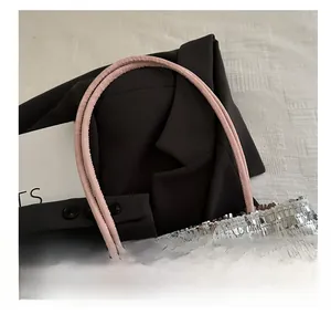 Close-up of pink handles and shimmering silver sequins on a large fashion tote bag