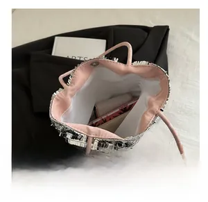 Close-up of silver sequin tote bag showing pink interior lining and spacious capacity