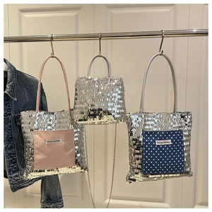 Detail of sequined tote bags with colorful pockets and metallic chain shoulder straps