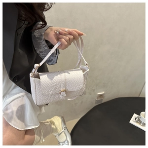 Detail showing white woven texture square shoulder bag with metal buckle closure