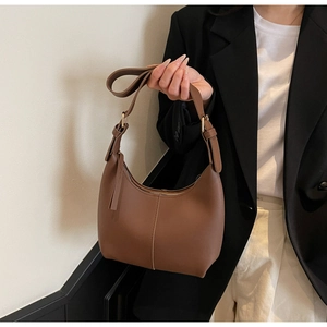 Brown hobo shoulder bag featuring smooth synthetic leather and sleek vertical stitching