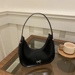 Classic black half-moon hobo bag with a silver metallic bow and smooth leather texture