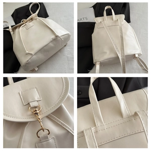 Detail view of white PU backpack featuring gold metal buckle and drawstring closure