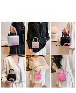 Detail view of mini square crossbody bags with decorative bows and metal chains