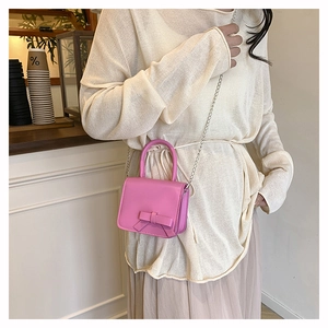 Pink mini crossbody bag for girls featuring a 3D bow and elegant silver chain strap