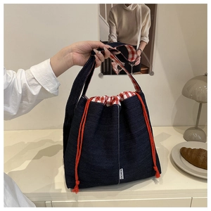 Detail of denim tote bag with red drawstring and checkered lining in Japanese style
