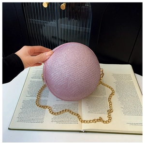 Close-up of pink sphere evening bag featuring sparkly glitter finish and gold chain
