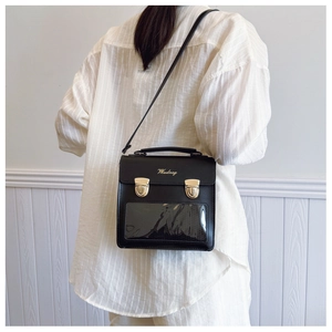Detail of black PU leather backpack with clear display window and gold metal buckles