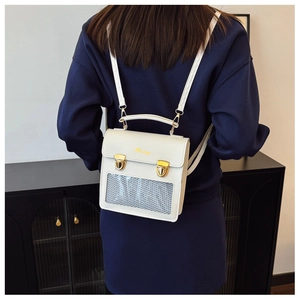 Detail view of a white PU leather backpack with a transparent window and gold push-locks