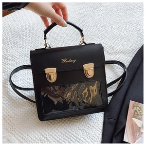 Detail of black crossbody bag with transparent window and adjustable strap for women