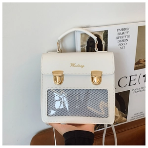 Detail of white PU leather clear window backpack with golden buckles and top handle