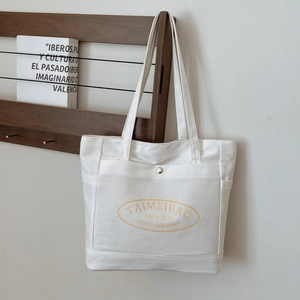 Large capacity off-white canvas tote bag with brand logo and functional front pocket