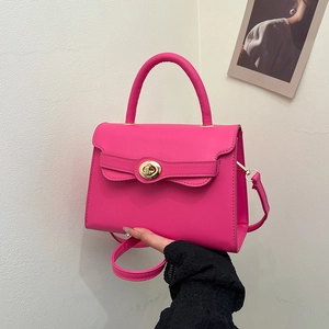 Elegant rose pink leather handbag with gold metal lock and detachable shoulder strap