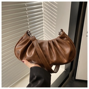 Detailed view of the brown ruched cloud bag showing soft PU leather texture and silver buckle