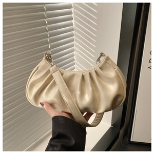 Detailed view of the soft pleated texture and silver hardware of the beige hobo cloud bag