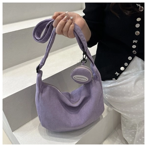 Detail of purple corduroy crescent tote bag with matching round coin purse and zipper