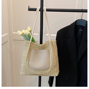 Detail of woven straw tote bag with PU pocket and soft cotton rope handles