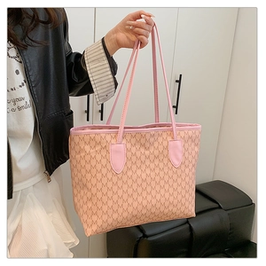 Lifestyle shot of large printed tote bag in pink with monogram and top handles
