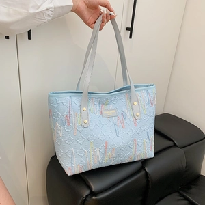 Light blue tote bag with letter embossing and colorful wavy embroidery for women