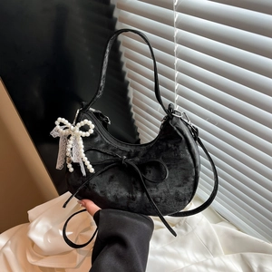 Chic black velvet crescent underarm bag with decorative bow and pearl lace charm