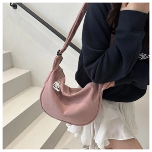 Rosafarbene Cord-Sichel-Tasche Detail mit niedlichem weißen Zeichentrick-Anhänger