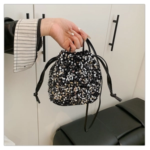 Detailed view of sequined bucket bag featuring metallic gold and silver textured patterns