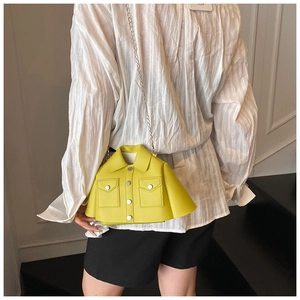 Detailed view of creative yellow jacket-shaped crossbody bag with metal chain strap