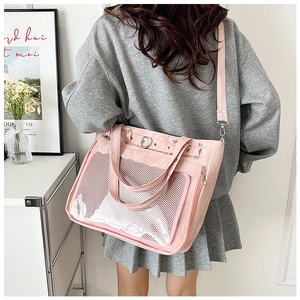 Rear view of a model carrying the pink ita bag with transparent window and heart hardware