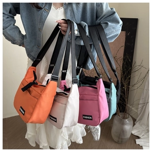 Close-up of colorful oxford fabric tote bags with adjustable straps and fashion labels