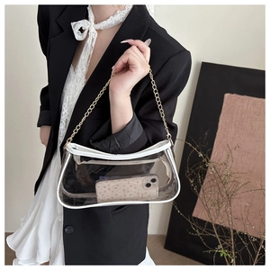 Close-up of transparent PVC shoulder bag with white leather trim and gold chain detail