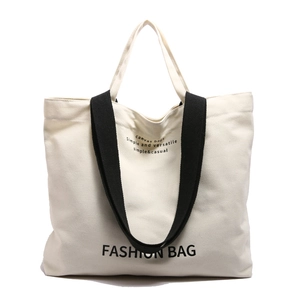 Minimalist canvas tote bag with black handles and fashion letter print in beige color