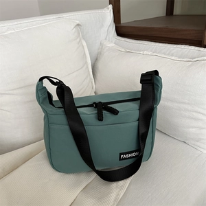 Large Oxford fabric crossbody tote bag in sage green with adjustable shoulder strap