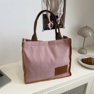 Pink corduroy tote bag with brown handles and fashion tag for daily school commuting