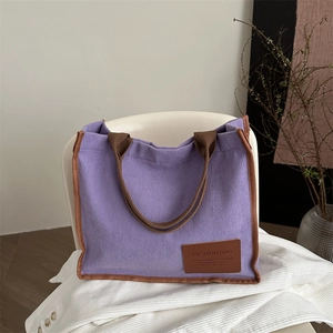 Purple corduroy tote bag with brown straps and leather trim for daily commute