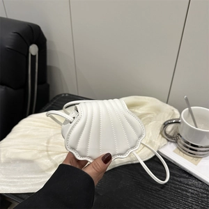 Minimalist white shell-shaped mini crossbody bag with stitched texture and thin strap