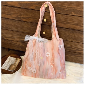 Detailed shot of pink marble pattern bag with floral print and white lace bow detail